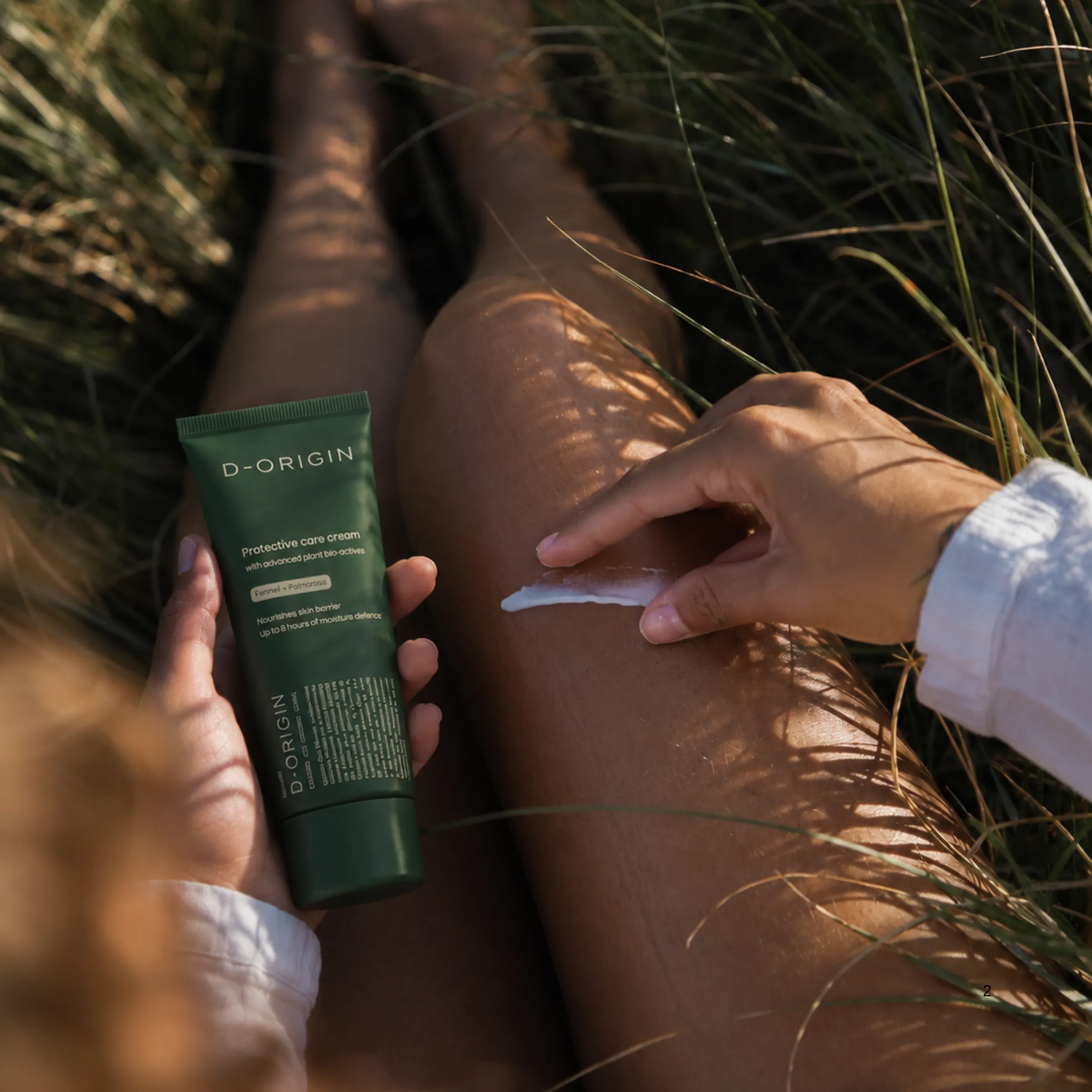 Applying protective bodycare cream outdoors in a sunlit field